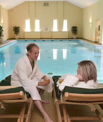 Couple relaxing by pool at Bodysgallen Spa Couple relaxing by pool at Bodysgallen Spa