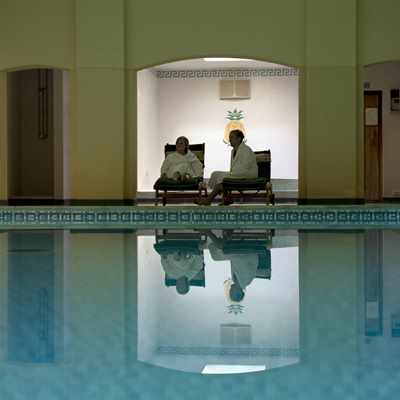 Couple relaxing beside the pool at Bodysgallen Spa Couple relaxing beside the pool at Bodysgallen Spa