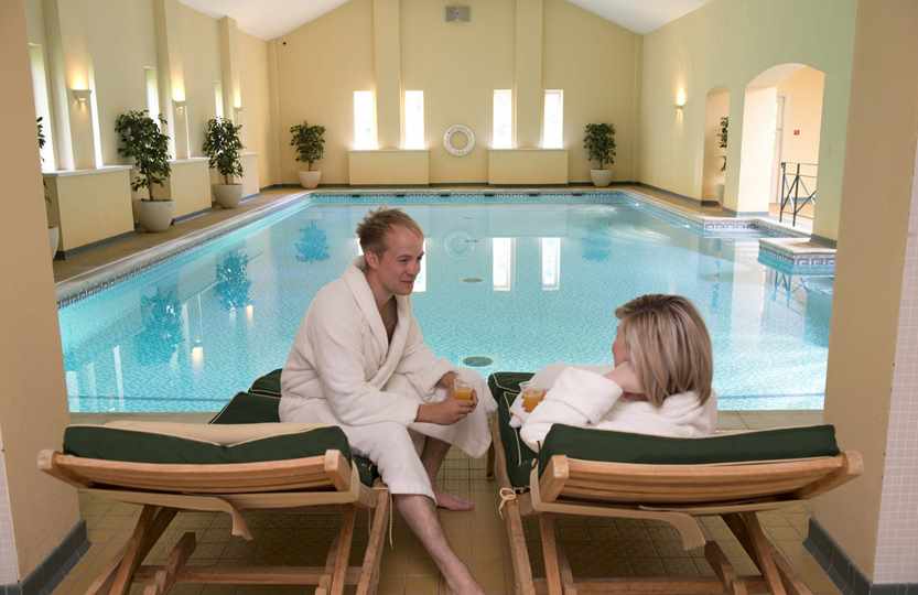 Couple relaxing by pool at Bodysgallen Spa Couple relaxing by pool at Bodysgallen Spa