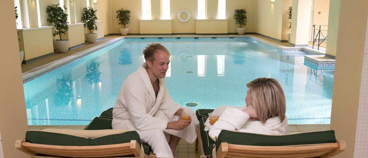 Couple relaxing at poolside at Bodysgallen Spa