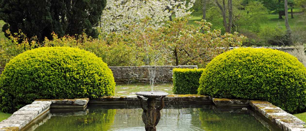 Spring blossom across lily pond at Bodysgallen Hall
