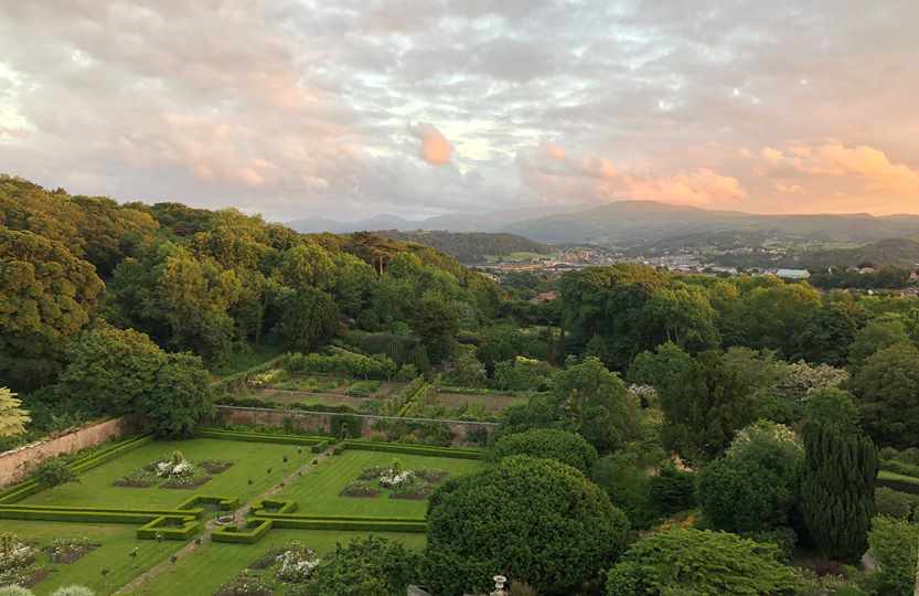 View across gardens at Bodysgallen Hall at sunset