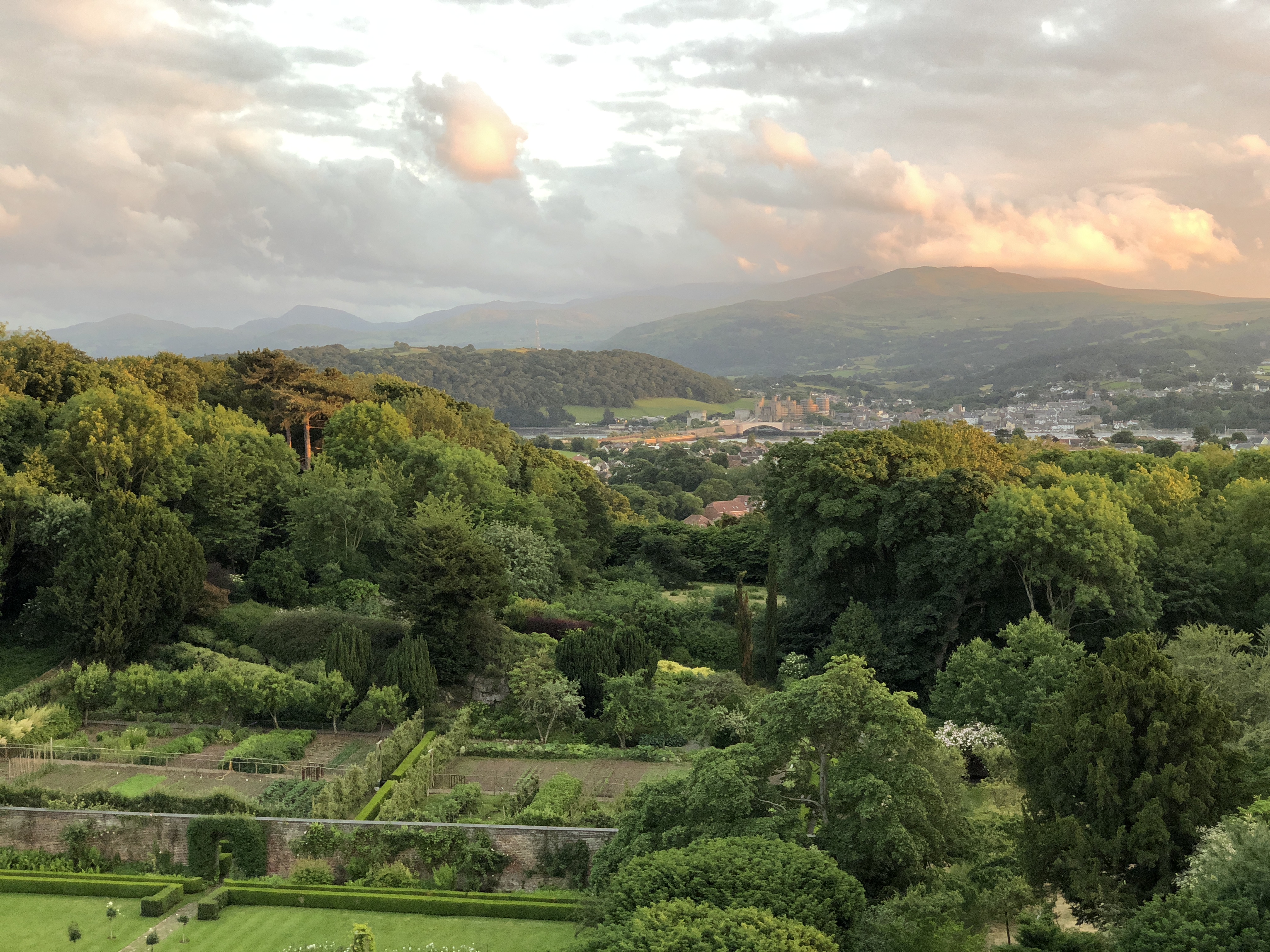 Bodysgallen Hall view across gardens to Conwy at sunset